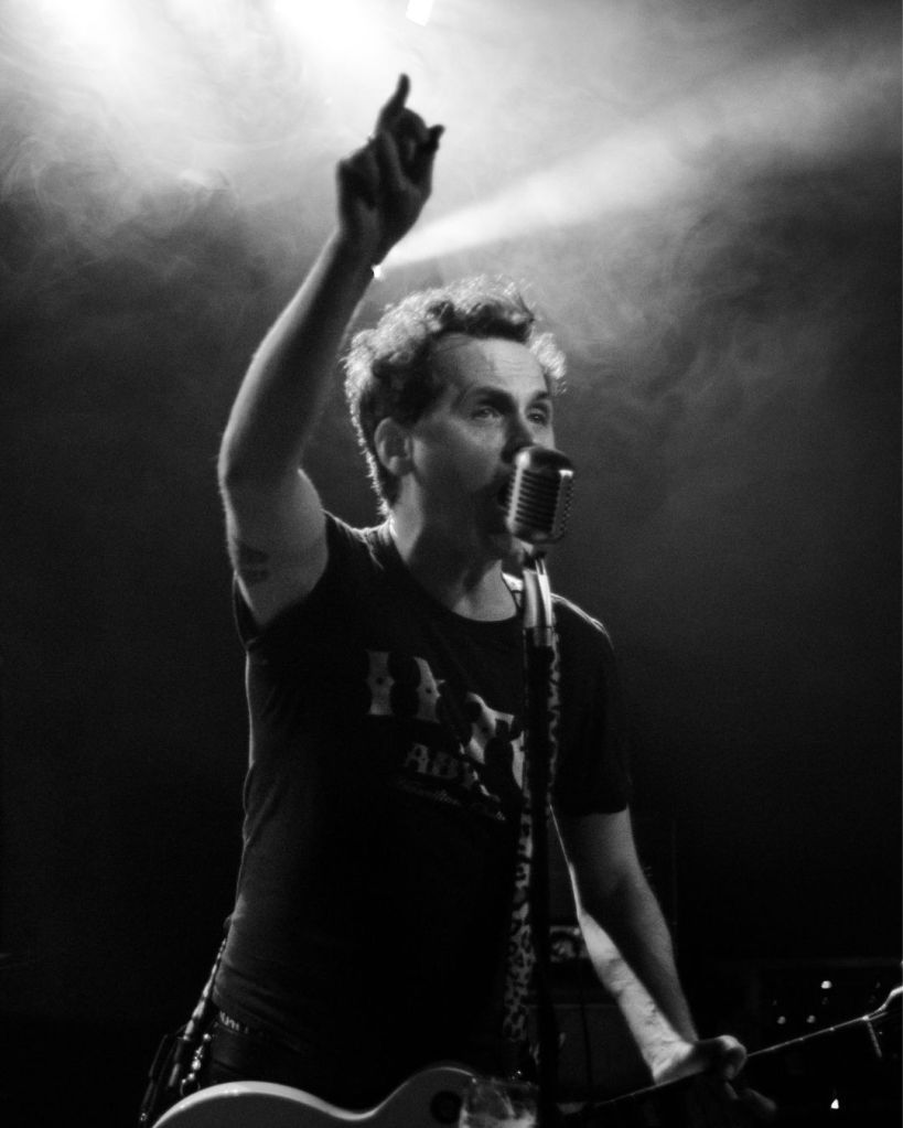 Adam Neumann lead singer and guitar player for The Commandos